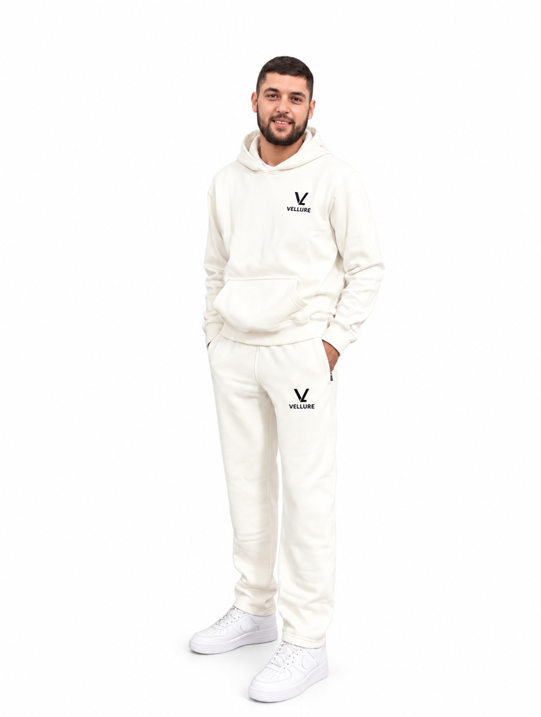 Tom wearing the cream VELLURE tracksuit on a plain white background